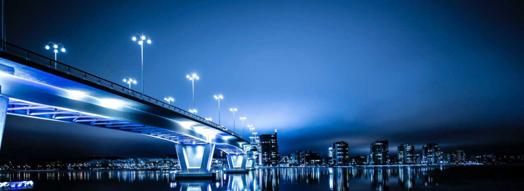 bridge at night with the lights on across river x